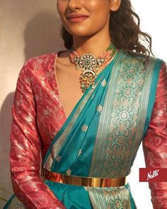 a woman wearing a blue and red sari