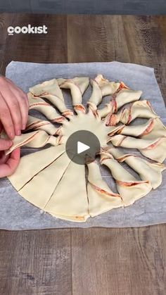 a person is making food on a wooden table