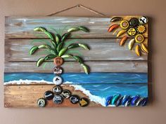 a wooden wall hanging with an image of a palm tree on the beach and several buttons attached to it