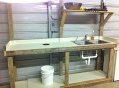 an unfinished sink and shelf in a garage