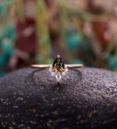 a close up of a ring on top of a rock