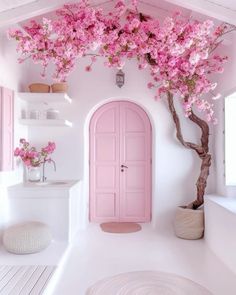 a pink door in the corner of a room with white walls and flooring that has flowers on it