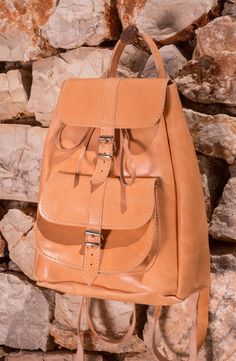 This leather backpack can easily be your every day companion, for your urban adventures and travels. Minimally styled so it can be used in many different occasions both for women and men, a truly unisex item. Made to easily accomodate everything you might need in a single day (extra clothes, books, camera, smartphone, laptop, tablet etc.), it measures approximately 12 inches high by 10 inches wide with a single interior space (with no interior lining) that closes with a leather cord plus a leath Casual Travel Satchel With Leather Lining, Casual Leather Shoulder Bag For Trip, Trip Backpack With Leather Lining, Travel Backpack With Leather Lining, Satchel Backpack With Leather Lining For Trips, Leather Lined Backpack For Trips, Adventure Leather Backpack With Adjustable Strap, Leather Backpack With Adjustable Strap For Trip, Leather Lined Satchel Backpack For Trips