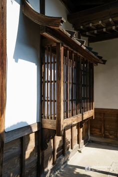 an old building with wooden slats and windows