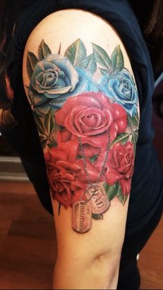 a woman's arm with roses and a locke on it