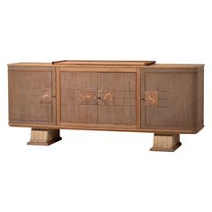 a wooden sideboard with carvings on the doors and two drawers, one door open