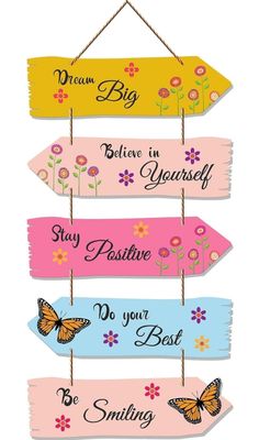 four wooden signs with butterflies hanging from them