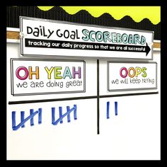 a sign that says daily goal scoreboard next to another sign with words on it