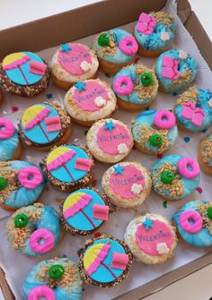 a box filled with lots of colorful donuts covered in frosting and sprinkles