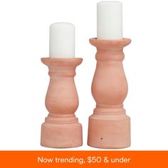 two candles sitting on top of each other with the words now trending, $ 50 & under