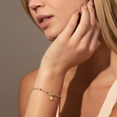 Every summer look needs our Beaded Shell Bracelet. This colorful bracelet features a gold shell charm that’s perfect for every beach trip. For a full look, pair this beaded bracelet with our Beaded Shell Necklace. Beach Bracelets With Gold Beads, Gold Beaded Bracelets With Letter Beads For Vacation, Gold Beaded Charm Bracelet For Beach, Beaded Stretch Bracelet For Vacation, Summer Gold Beads Bracelets For Beach, Beach Friendship Bracelets With Gold Beads, Multicolor Friendship Bracelets With Gold Beads For Beach, Gold Stretch Bracelet With Colorful Beads For Summer, Casual Beaded Bracelet With Gold Beads For Beach