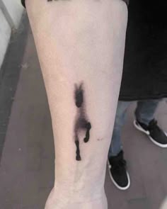 a person with a black ink horse tattoo on their leg