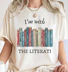 Celebrate your love for literature and freedom of expression with our Banned Books Shirt, I'm With The Literati Shirt, Banned Books T-Shirt, Teacher Shirt, Gift for Book Lovers, Reading and Librarian Shirt, crafted from the high-quality Comfort Colors 1717 garment-dyed tee. This shirt is more than just apparel--it's a statement piece for book lovers, educators, and advocates of free speech. Featuring a unique design of classic banned books, this tee is perfect for those who proudly stand with th Bookish Text Print Tops For School, Bookish Cotton Tops For School, Bookish Crew Neck Shirt With Letter Print, Literary Tops With Letter Print For School, Literary Style Tops With Letter Print For School, Banned Books Shirt, I Read Banned Books, Dark Academia Shirt, Library Shirt