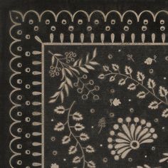 a black and white rug with flowers, leaves and vines on the bottom half of it