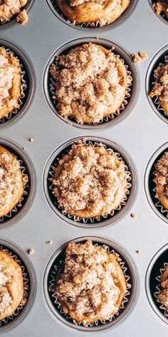 muffins with crumbs and powdered sugar in a baking pan ready to be baked