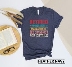 a t - shirt that reads retired under new management see grandkids for details