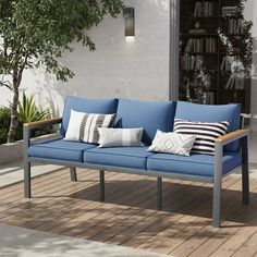 a blue couch sitting on top of a wooden floor