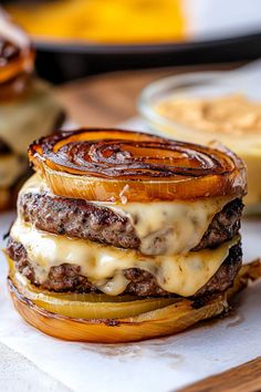 a cheeseburger with onion rings on top