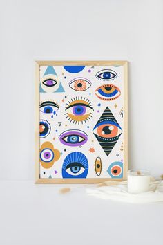 an eye print on a white wall next to a candle and some candlesticks