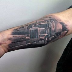 a man's arm with a truck tattoo on it