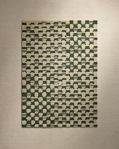 a piece of art that looks like an abstract pattern on a white background with green and beige squares