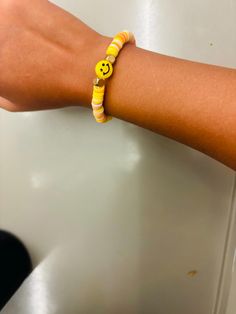 Sunny Smiles is a bracelet with yellow and a smiley face charm in the middle! Fun Smiley Face Round Bead Bracelets, Yellow Beaded Bracelets With Smiley Face, Playful Smiley Face Beaded Bracelets, Adjustable Yellow Smiley Face Bracelet, Playful Multicolor Smiley Face Beaded Bracelets, Smiley, Sunnies, Favorite Jewelry, Jewelry Bracelets