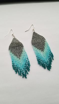 Pretty fringe earrings done in different tones of pretty blues. Your fringe earrings are best stored completely flat or hanging to keep the dangling strands dangling nicely.  The earring wires are nickel free. ஐ ¸.**'¯) ஐ ¸.**'¯) ஐ ♥ All items handmade in beautiful Nova Scotia, Canada ♥ ** To check out other handmade designs in my shop: http://www.etsy.com/shop/EnlightenedSpirit ** Payment & shipping policy:  http://www.etsy.com/shop/EnlightenedSpirit/policy ** Questions? Don't hesitate to convo Blue Fringed Beaded Drop Earrings, Blue Fringe Beaded Drop Earrings, Blue Fringe Dangle Chandelier Earrings, Blue Long Drop Tassel Jewelry, Bohemian Blue Tassel Chandelier Earrings, Turquoise Fringe Tassel Drop Earrings, Blue Dangle Tassel Earrings With Fringe, Bohemian Blue Chandelier Earrings With Fringe, Blue Bohemian Chandelier Earrings With Fringe