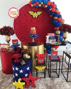 wonder woman themed party with balloons, decorations and tableware on carpeted flooring