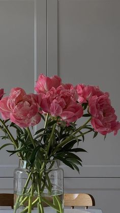 a vase filled with pink flowers on top of a table