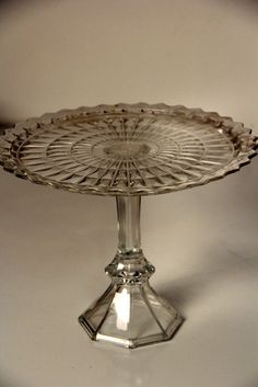 a clear glass cake plate on a white table