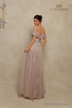 Capture hearts with the ethereal beauty of Tarik Ediz 98079. This A-Line Off the Shoulder Long Evening Dress in Chiffon and Tulle features a romantic V-Neck, mesmerizing pleating, and delicate floral embellishments. The strapless style and open back create a graceful allure for your special occasion. #EtherealBeauty #RomanticElegance #EnchantingCharm Wedding Gown Simple Elegant, Wedding Gown Simple, Plastic Dress, Tarik Ediz, Full Length Gowns, Unique Prom Dresses, Tulle Fabric, Evening Dresses Long, Gorgeous Dresses