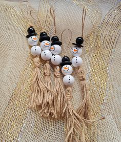 five snowmen with black hats and tassels on their heads