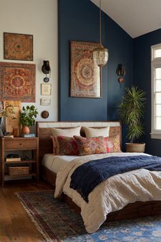 a bedroom with blue walls and wooden floors