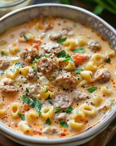 a white bowl filled with pasta and meat soup