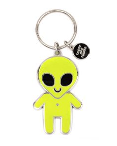 an alien keychain with a black and white logo on the front, it has a