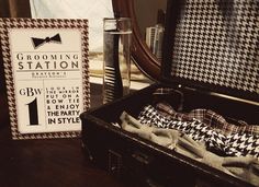 an open suit case sitting on top of a table next to a sign and tie