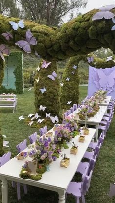 a long table covered in purple flowers and butterflies