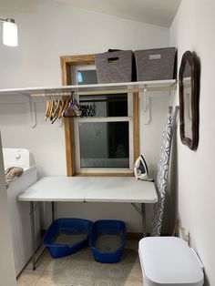 a white desk with two blue buckets under it