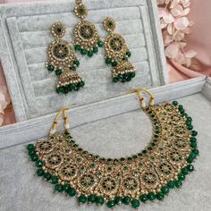 Beautifully flexible Antique Gold intricate necklace set scattered with dazzling golden crystals and green bead detailing Comes with matching long jhumka earrings (approx 3 inch length x 1.5 inch width) and matching tikka ( pendant part 2 inch length x 1.5 inch width)  Ready to ship as seen with gift box! Festive Green Bridal Necklace With Latkans, Green Kundan Bridal Necklace With Latkans, Festive Green Jewelry Sets With Latkans, Green Kundan Necklaces With Latkans, Green Kundan Jewelry Sets With Intricate Design, Green Jewelry Sets With Latkans For Diwali, Bollywood Style Green Jeweled Bridal Necklace, Festive Green Jeweled Bridal Necklace, Bollywood Green Jewelry Sets With Intricate Design