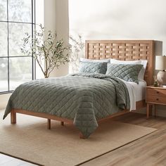 a bed in a room with a wooden headboard and foot board on the side