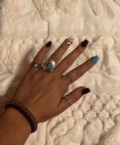 a woman's hand with several rings on it