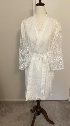 Wedding Dressing Robe.  One of a kind custom made wedding dressing robe made from an actual wedding gown.  I will work closely with you to make sure your memory wedding robe vision is my vision.  After I receive dress we will discuss fabric layout, embellishments, personalization embroidery, and special touches. Memory Robe requires approximately 2-3 yards of fabric.  This is s special way to incorporate a wedding dress from the past for a present day bride.   Made in a pet free, smoke free environment. How it works:  You will send me the wedding gown and I will use the fabric to create a beautiful and practical wedding day dressing gown for the bride to be.  I take extra special care to incorporate the details and embellishments of the wedding gown into the new item.  This is a beautiful Wedding Dressing, Memory Wedding, Wedding Memory, Practical Wedding, Wedding Robe, A Wedding Dress, Wedding Memorial, Dressing Gown, Bride To Be