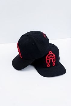 Peruvian Brothers' Iconic Chullo Logo on a flat brim black hat with white embroidery. Red Adjustable Flat Brim Fitted Hat, Black Hat With Embroidered Logo And Curved Brim, Black Adjustable Fitted Hat With Embroidered Logo, Adjustable Black Fitted Hat With Embroidered Logo, Black Hat With Embroidered Logo And Flat Brim, Black Flat Brim Hat With Embroidered Logo, Black Adjustable Snapback Hat With Flat Crown, Adjustable Black Snapback Hat With Flat Crown, Red Adjustable Hats With Flat Crown