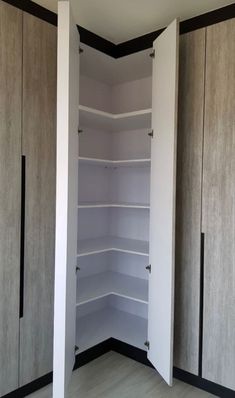 an empty closet with several shelves and doors