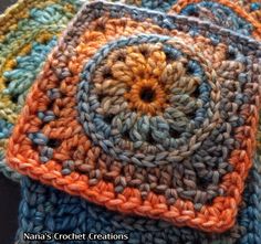 three crocheted coasters sitting on top of each other in different colors and sizes