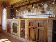 a kitchen with wooden cabinets and tiled walls