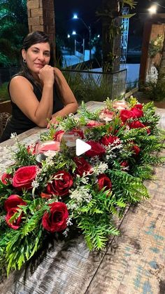 a woman sitting at a table with flowers on it