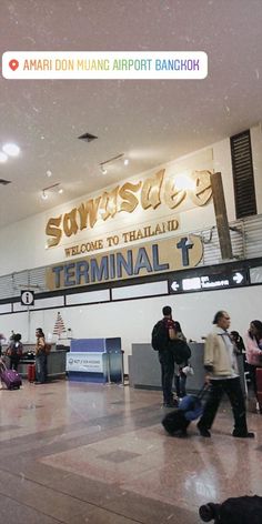 people are walking through an airport with luggage