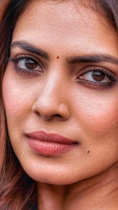 a close up of a woman's face with brown eyes