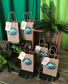 small brown paper bags with blue dolphins on them are sitting in front of a green curtain